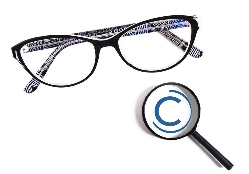 chadwick-optical-measurements-eyeglasses-meaning Stylish patterned eyeglasses with a magnifying glass showing a copyright symbol on a white background.